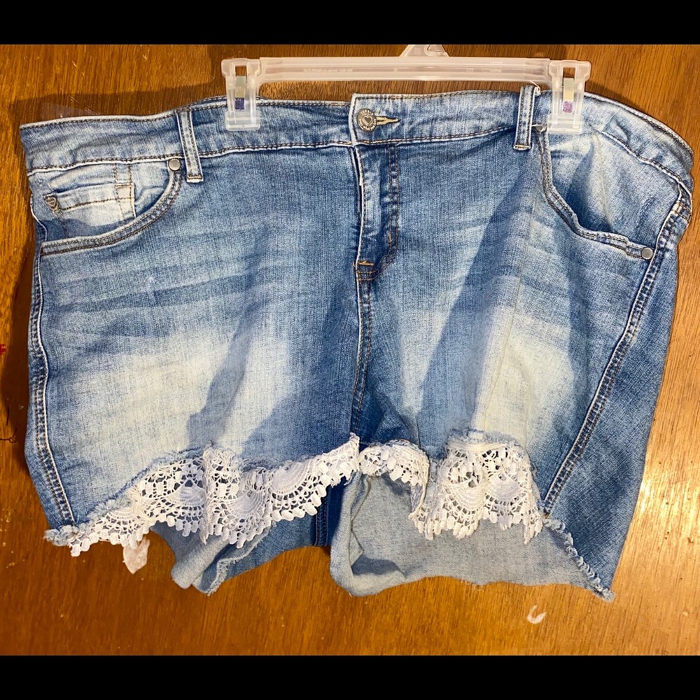 Blue jean shorts with lace and distress detail